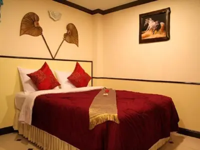 a bedroom with a large bed with red pillows at Honey House 2 in Bangkok