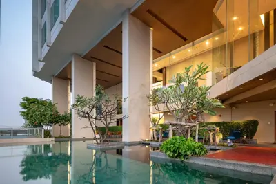 an external view of a building with a swimming pool at Jasmine Resort Bangkok in Bangkok
