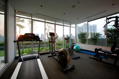 a gym with two treadmills and a large window at Jasmine Resort Bangkok in Bangkok