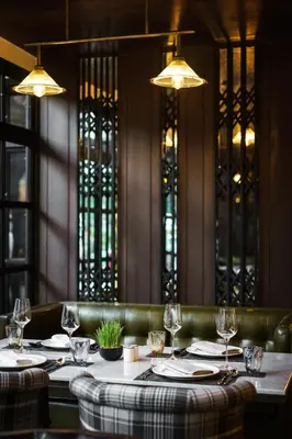 a dining room with a table with wine glasses at Tastoria Collection Sukhumvit in Bangkok
