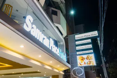 a sign for a restaurant on the side of a building at Samran Place Hotel in Bangkok