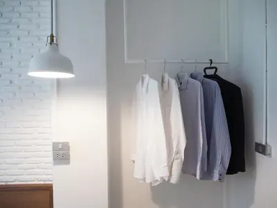 a closet with clothes hanging on a rack at Varmtel in Bangkok