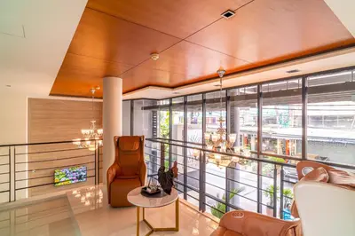 a living room with a large window and a chair at Amber Boutique Silom in Bangkok