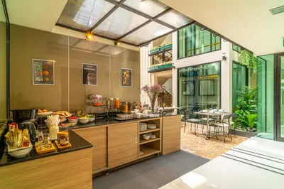 a kitchen with a counter with food on it at Amber Boutique Silom in Bangkok