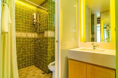 a bathroom with a sink and a shower and a toilet at Amber Boutique Silom in Bangkok