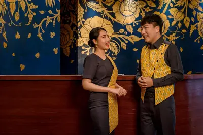 a man and a woman standing next to a wall at VELA be Bangkok Ratchathewi in Bangkok