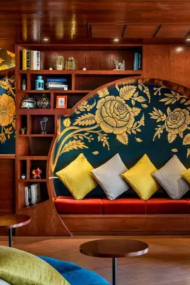 a couch with pillows on it in a living room at VELA be Bangkok Ratchathewi in Bangkok