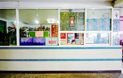 a fast food restaurant with a window at Kaya Place in Bangkok