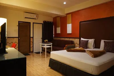 a hotel room with a bed and a couch at Kaya Place in Bangkok