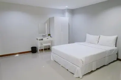 a white bedroom with a white bed and a desk at S44ROOM in Bangkok