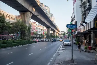 a city street with a bridge and cars on the road at S44ROOM in Bangkok