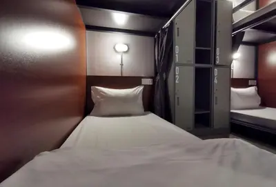 a small room with a white bed in it at Apartment45 Hostel in Bangkok