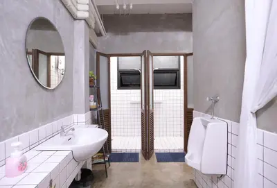 a bathroom with a sink and a toilet and a mirror at Apartment45 Hostel in Bangkok