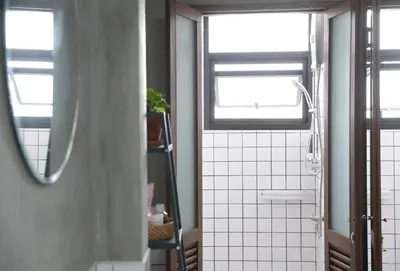 a bathroom with a shower and a sink and two windows at Apartment45 Hostel in Bangkok
