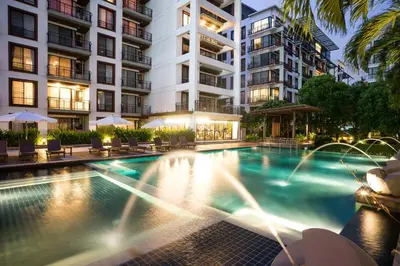 a swimming pool in front of a building at Amanta Hotel & Residence Ratchada in Bangkok