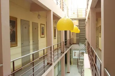 a hallway of a building with a yellow light fixture at PR Place Hotel in Bangkok