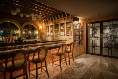 a bar with chairs and a counter in a room at Park Plaza Bangkok Soi 18 in Bangkok