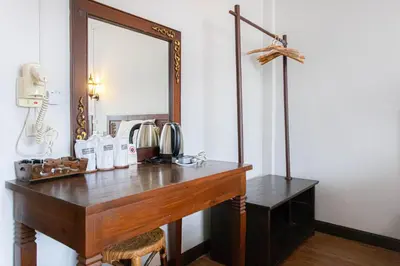a dressing table with a mirror on a wall at SK Boutique Mahanakhon in Bangkok