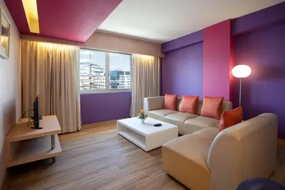a living room with a couch and a table at Veronica Residence in Bangkok