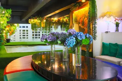 a group of vases with flowers on a table at Diamond City Hotel SHA Certified in Bangkok