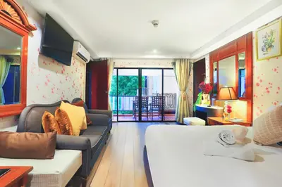 a living room with a bed and a couch at Diamond City Hotel SHA Certified in Bangkok