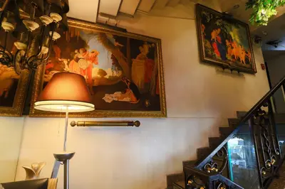 a hallway with a painting on the wall and a lamp at Diamond City Hotel SHA Certified in Bangkok