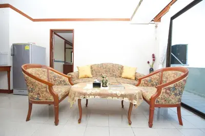a living room with a couch and a table at Poonchock Mansion in Bangkok