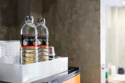two bottles of water sitting on top of a refrigerator at Buddy Boutique Inn in Bangkok