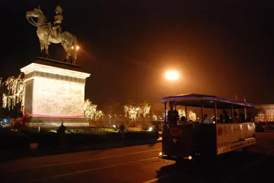 a group of people riding a trolley at night at Buddy Boutique Inn in Bangkok