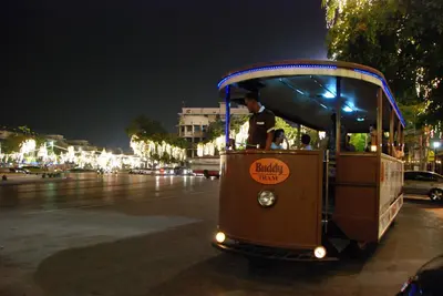 a trolley car on a city street at night at Buddy Boutique Inn in Bangkok