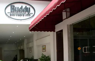a restaurant with a sign on the side of a building at Buddy Boutique Inn in Bangkok