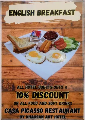 a plate of breakfast food with eggs and toast at Khaosan Art Hotel in Bangkok