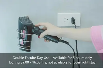 a person holding a hair dryer in their hand at Peace Factory Hostel in Bangkok