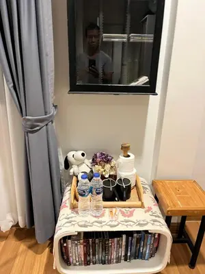 a table with a tray of dvds and water bottles at Autta house in Ban Lat Tanot