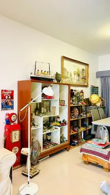 a room with a shelf of shoes and a lamp at Autta house in Ban Lat Tanot