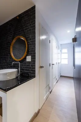 a bathroom with a sink and a mirror on the wall at Siam Star Hotel in Bangkok