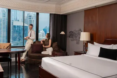 a man and a woman standing in a hotel room at Hotel Muse Bangkok, Autograph Collection by Marriott in Bangkok