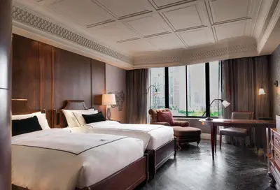 a hotel room with two beds and a desk at Hotel Muse Bangkok, Autograph Collection by Marriott in Bangkok
