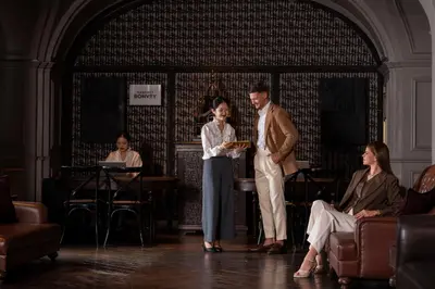 a man and a woman standing on a stage at Hotel Muse Bangkok, Autograph Collection by Marriott in Bangkok