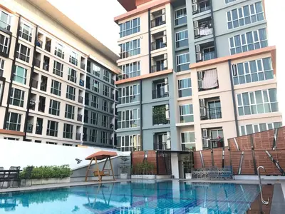 a swimming pool in front of tall buildings at Central Mansion in Bangkok