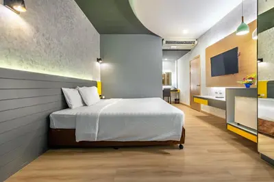 a bedroom with a bed and a bathroom at Qiu Hotel Sukhumvit - BTS On Nut Station in Bangkok