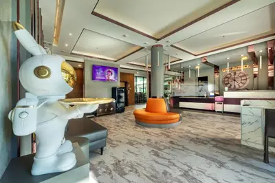 a room with a robot statue in the middle of it at Qiu Hotel Sukhumvit - BTS On Nut Station in Bangkok