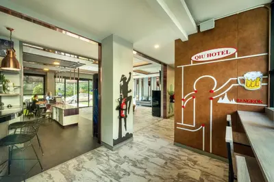 a restaurant with a door with a picture of a person on it at Qiu Hotel Sukhumvit - BTS On Nut Station in Bangkok