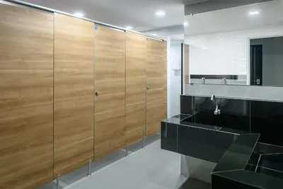 a bathroom with wooden panels and a black sink at Travelier Hostel in Bangkok