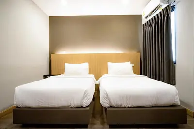 two beds sitting next to each other in a room at Travelier Hostel in Bangkok