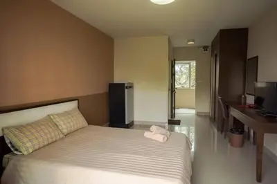 a bedroom with a bed with a towel on it at Crystal Place Parkkred in Nonthaburi