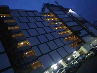 a tall building with a lot of windows at night at Crystal Place Parkkred in Nonthaburi