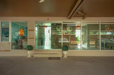 a store front of a building with windows and plants at Crystal Place Parkkred in Nonthaburi