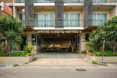 a building with a sign that reads greek price up serviced at Crystal Place Parkkred in Nonthaburi