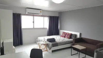 a small bedroom with a bed and a couch at Popular Condo C5 IMPACT in Pak Kret